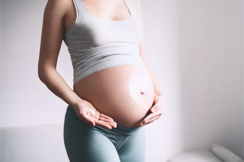 pregnant woman applying moisturizer cream on her b 2023 11 27 05 02 49 utc